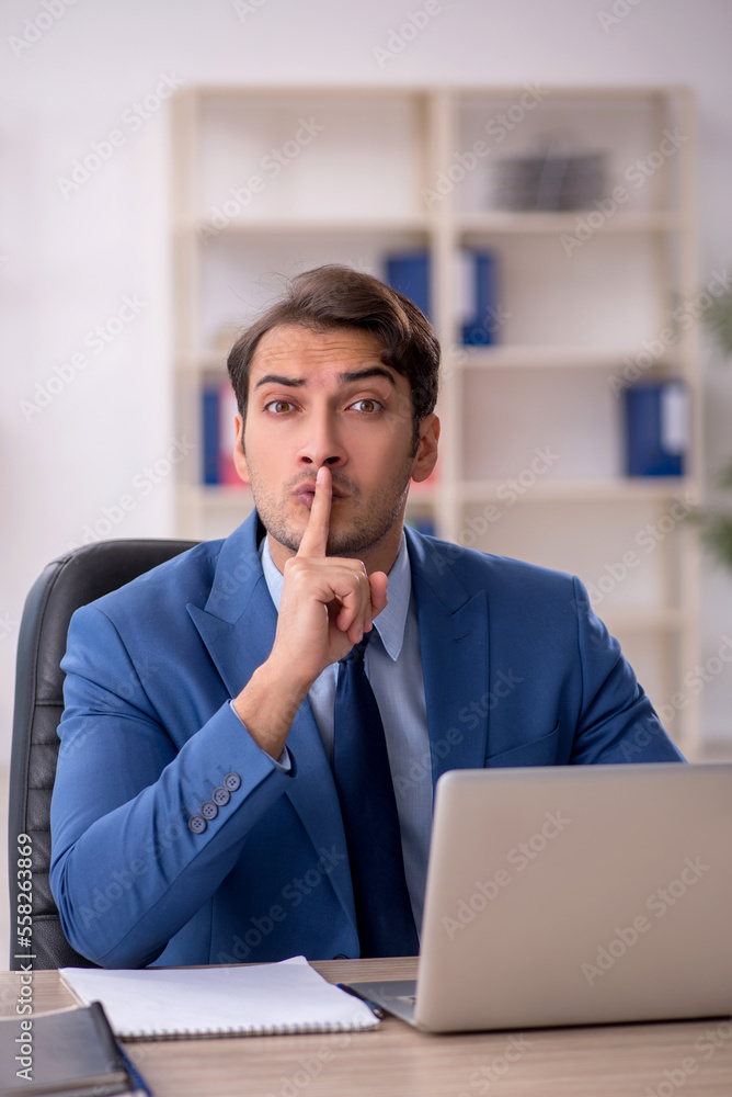 Young male employee and too much work in the office Young male employee and too much work in the office
