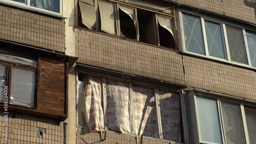 Consequences of rocket attack on the center of Ukraine. Funnel from a drone explosion. Attack of Iranian Shahed 136 drones on Kyiv. Damaged residential building. Broken windows and holes from debris. 