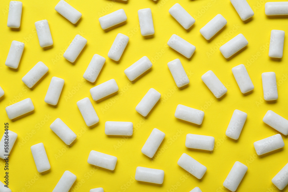 Tasty white chewing gums on yellow background, flat lay