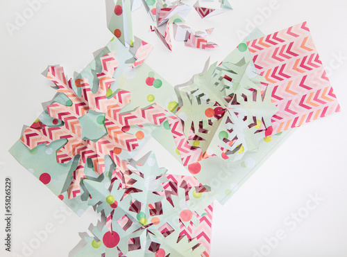 Colorful paper snowflakes on a white background