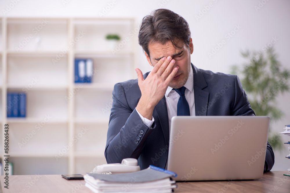 Young male employee working in the office Young male employee working in the office