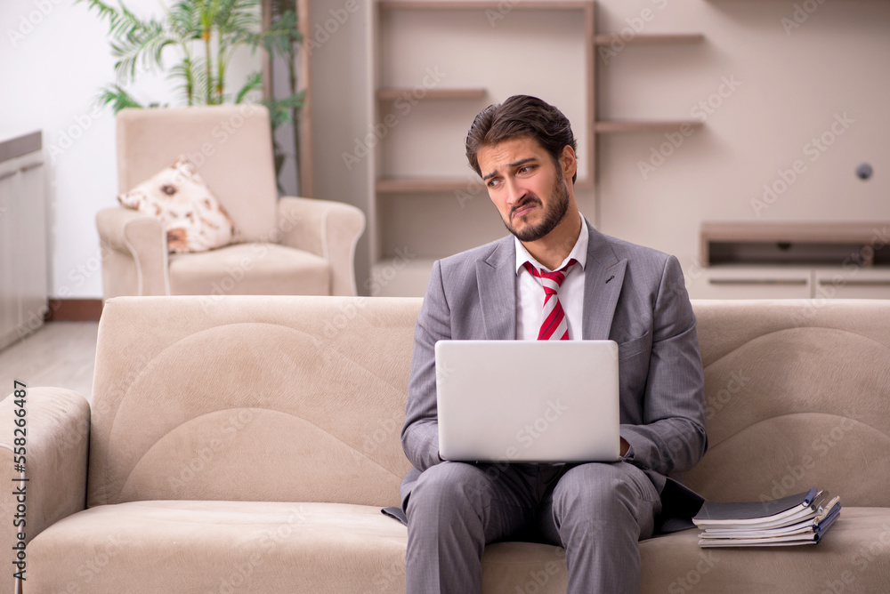 Young male employee working from home during pandemic Young male employee working from home during pandemic