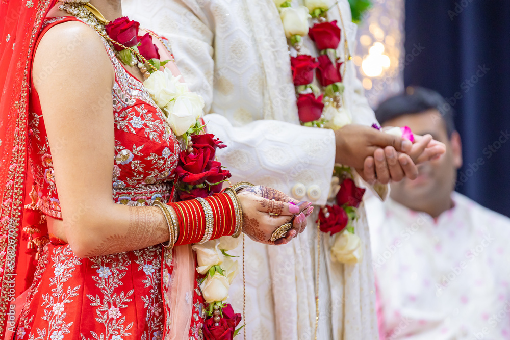 Indian Hindu wedding ceremony pooja bride and groom's hands close up