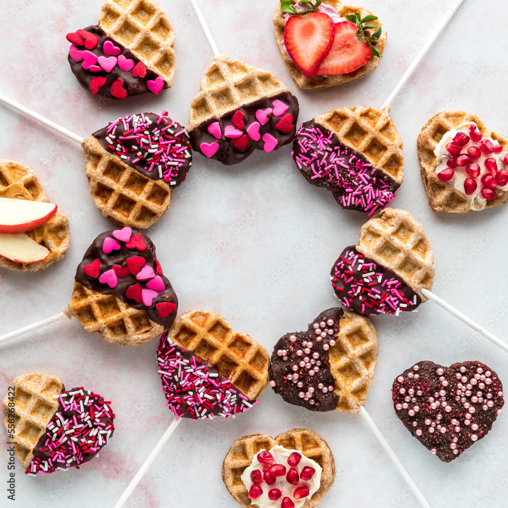 Decorated heart shaped waffle pops in a circle with copy space in the middle