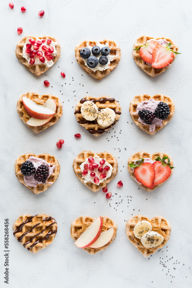 Heart shaped mini waffles with various toppings of spreads and fresh fruit.