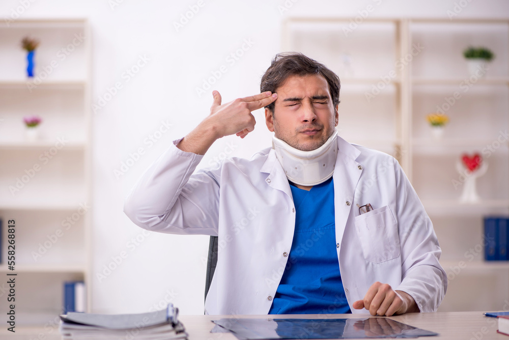 Young male doctor holding neck brace