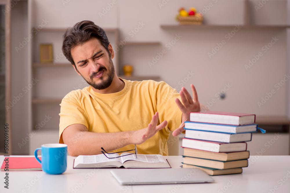 Young male student preparing for exams at home Young male student preparing for exams at home