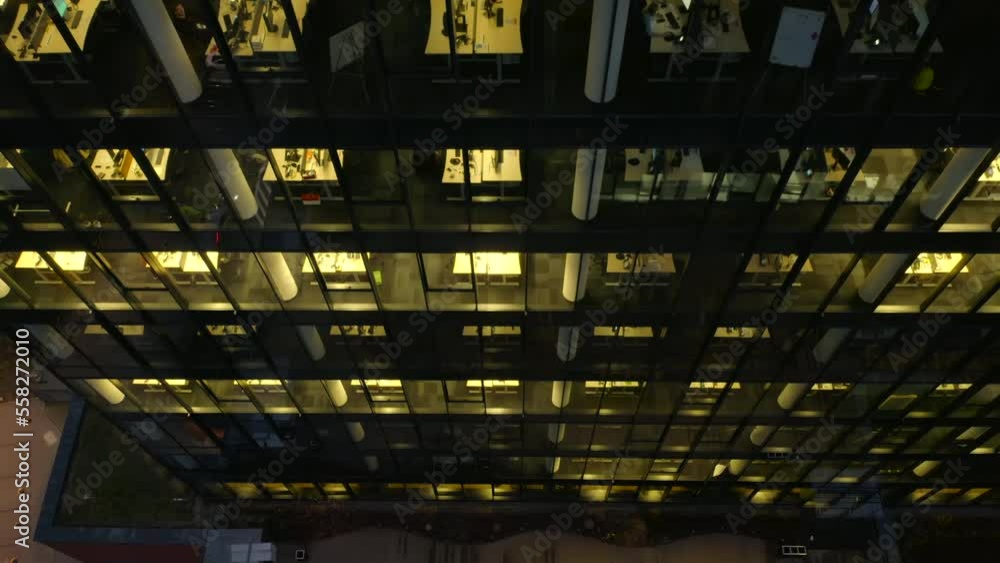 Drone shot on the Office building windows at night and aerial view of a skyscraper building with many corporate offices of successful companies. Real estate for rent and commercial using. Drone shot on the Office building windows at night and aerial view of a skyscraper building with many corporate offices of successful companies. Real estate for rent and commercial using.