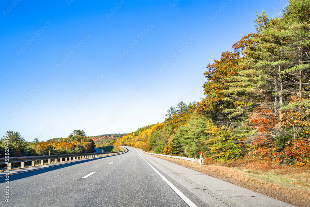 Divided highway road framed by autumn colorful maples in New England Divided highway road framed by autumn colorful maples in New England