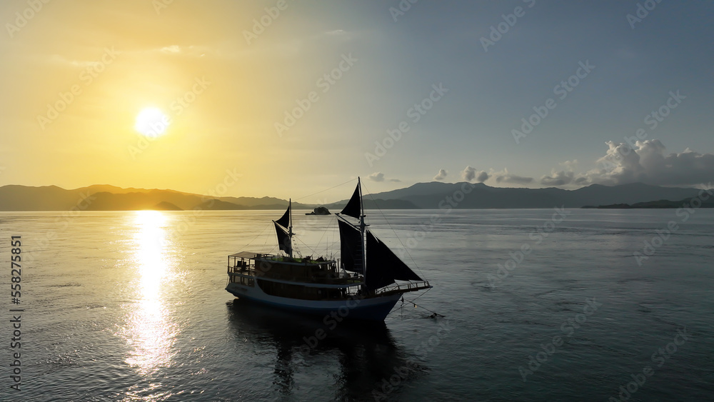 Aerial top view of a traditional boat in beautiful sea bay with turquoise crystal clear water, 