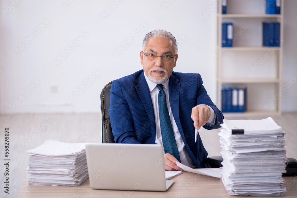 Old male employee and too much work in the office Old male employee and too much work in the office