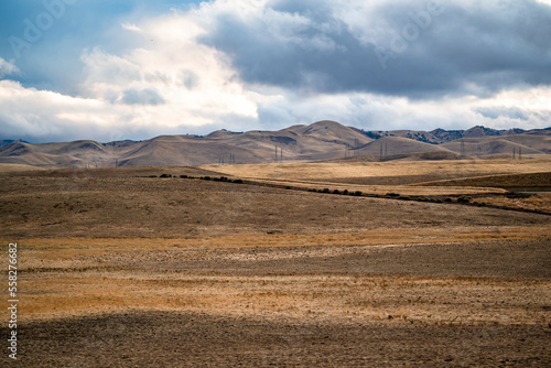 Mild agricultural landscape of plowed fields on hilly terrain ready for spring sowing