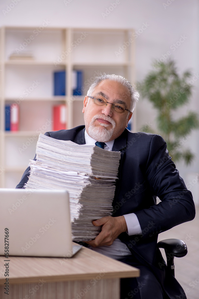 Old male employee and too much work in the office Old male employee and too much work in the office