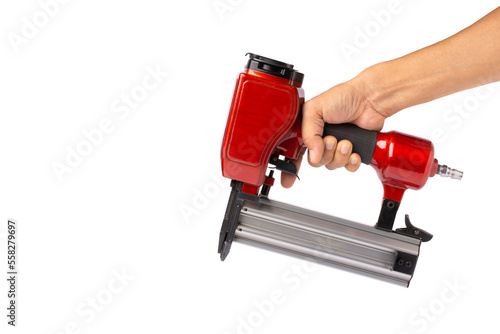 Man hand holding electric nail gun (pneumatic gun) isolated white background with clipping path. photo