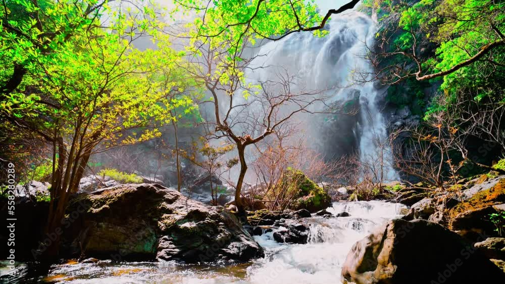 waterfall in the mountains, Khlong Lan Waterfall, Khlong Lan National Park, Kamphaeng Phet, in Thailand.Onsen atmosphere. waterfall in the mountains, Khlong Lan Waterfall, Khlong Lan National Park, Kamphaeng Phet, in Thailand.Onsen atmosphere.