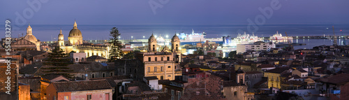 Catania medieval city center, with Sant'Agata cathedral and medieval town rooftops, and modern port terminal in the Mediterranean sea, Sicily, Italy