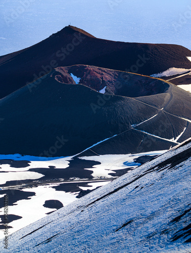 Etna volcano craters under snow at sunset, Sicily, Italy