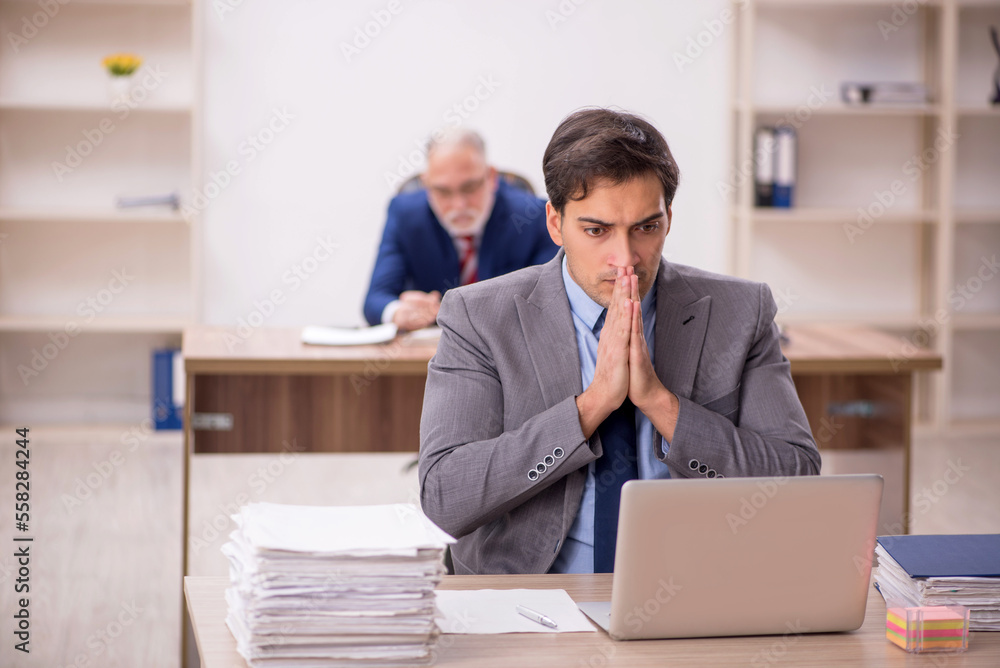 Two male colleagues sitting in the office Two male colleagues sitting in the office