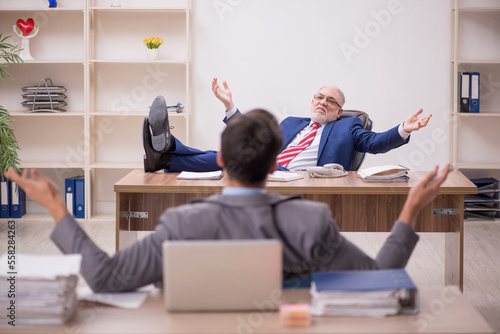 Two male colleagues sitting in the office