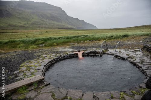 A young boy in a hot spring on the north coast of Iceland photo