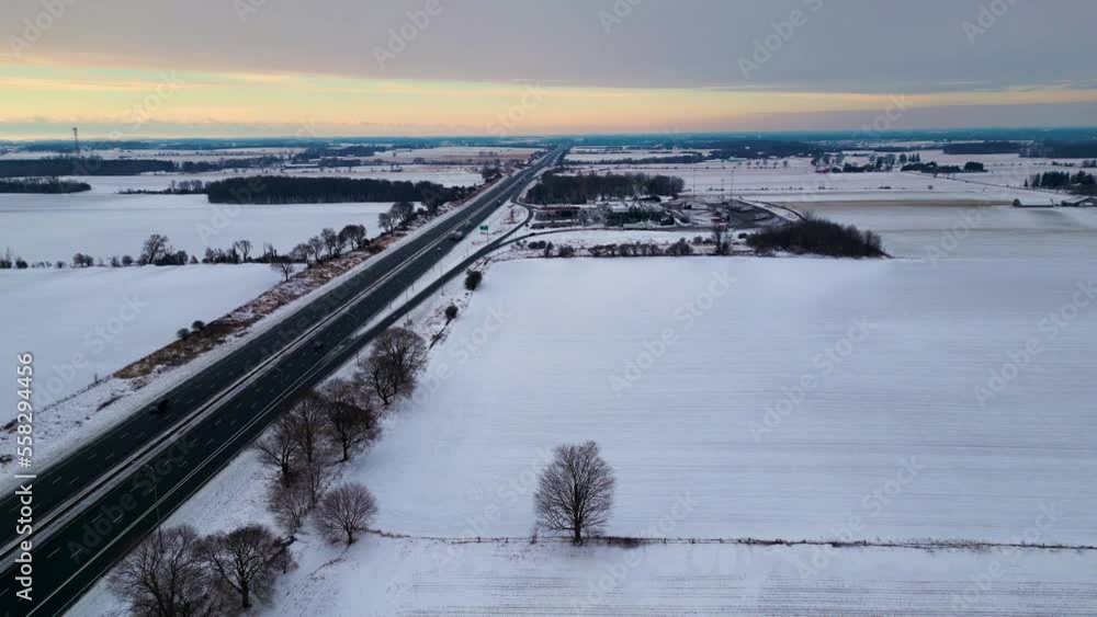 Canada highway 401 gas station covered in snow with farm and field in background 60fps aerial drone shot dolly, winter Canada highway 401 gas station covered in snow with farm and field in background 60fps aerial drone shot dolly, winter
