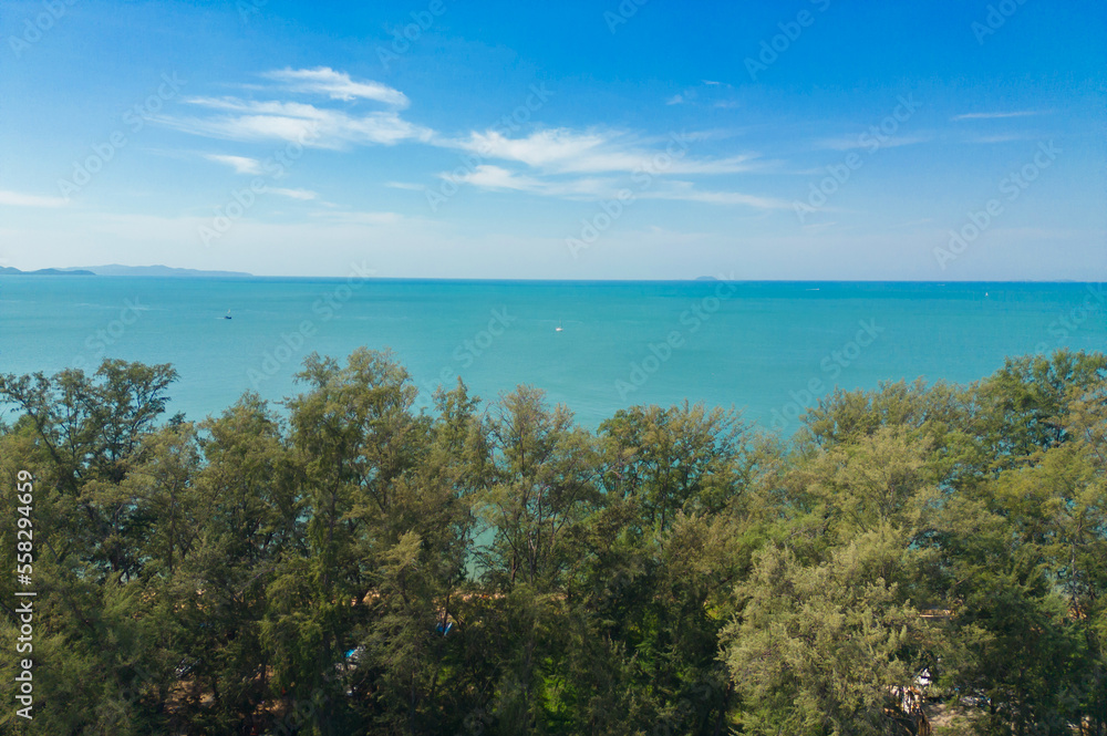 Aerial view of palm trees with clear blue turquoise seawater, Andaman sea in Phuket island in summer season, Thailand. Water in ocean material pattern texture wallpaper background. Aerial view of palm trees with clear blue turquoise seawater, Andaman sea in Phuket island in summer season, Thailand. Water in ocean material pattern texture wallpaper background.