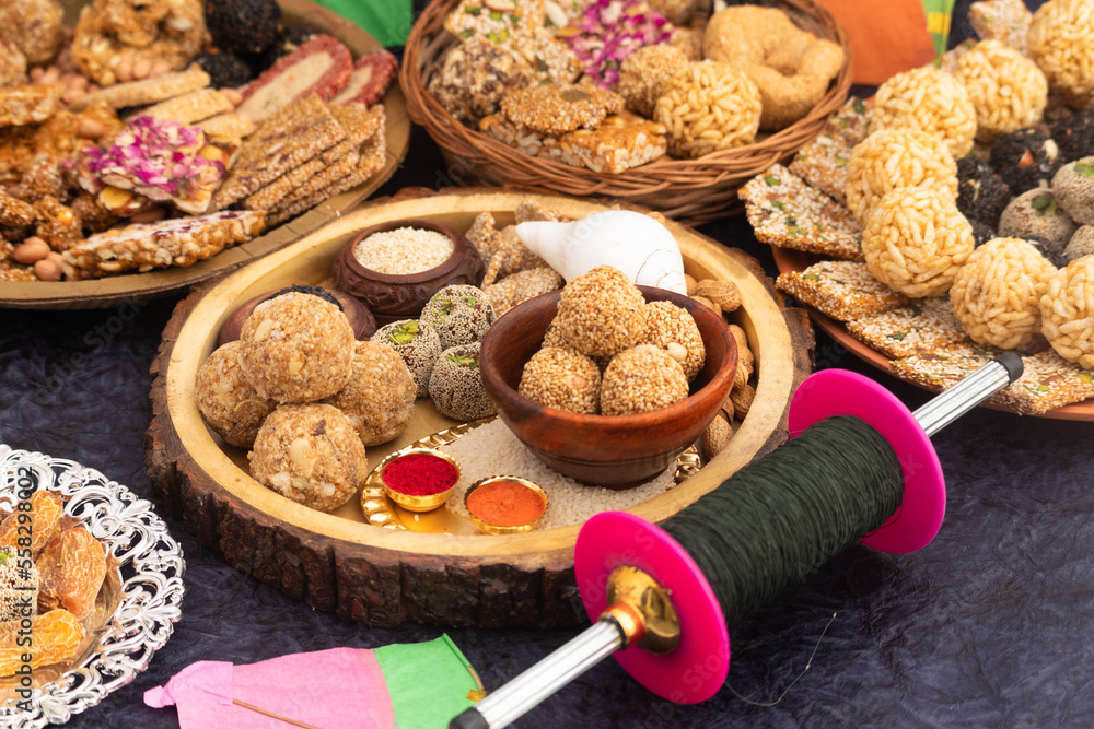 Harvest Festival Is Celebrated As Makar Sankranti, Lohri, Uttarayan, Maghi, Poush Sankranthi, Magh Bihu With Sesame Sweet viz. Tilgul, Til Mithai, Gajak, Chikki, Tilkut, Patang, Firki And Peanuts - obrazy, fototapety, plakaty 