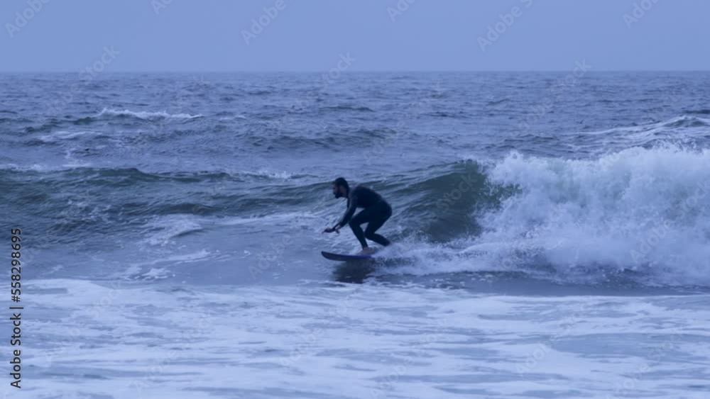 young an athlete surfer riding some waves In Carcavelos With line and style. young an athlete surfer riding some waves In Carcavelos With line and style.
