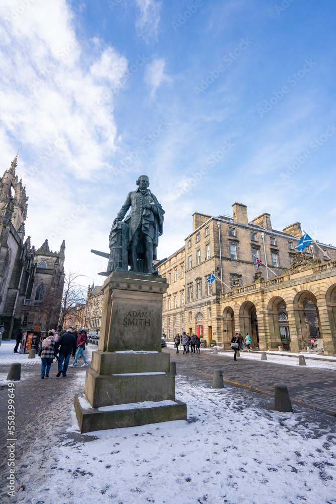 St Giles' Cathedral , Romanesque style church and Adam Smith Statue at the Royal Miles Street in Edinburgh old towns during winter in Edinburgh , Scotland : 28 February 2018