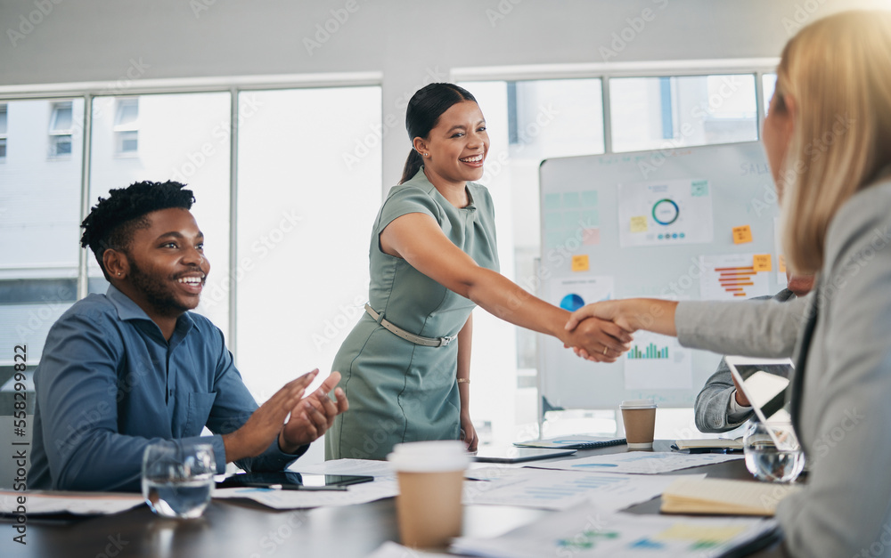 Obraz premium Business people, woman and handshake at meeting, planning and chart on board for target, success or goal. Corporate finance group, applause and celebration for profit, promotion or vision in New York