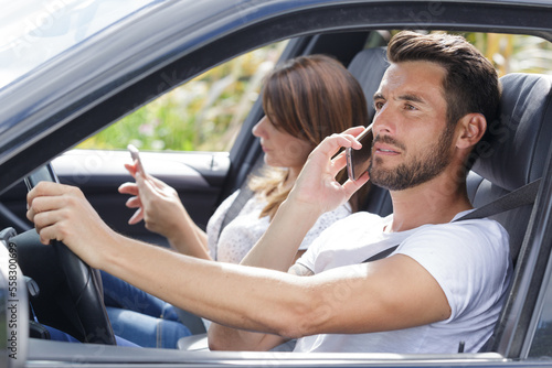man driving car and using mobile phone © auremar
