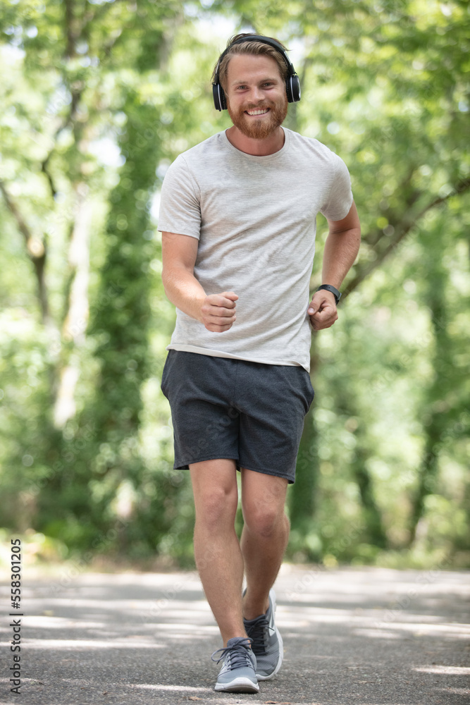 man wearing headphones is fast walking man wearing headphones is fast walking