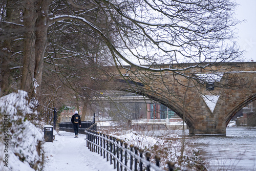 Beautiful Framwellgate Bridge over the River Wear with city view along the river during winter snow morning in Durham , United Kingdom : 1 March 2018 photo