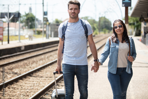 loving couple tourist holding hand at train station