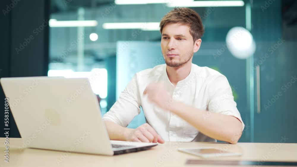 Focused concentrated developer typing on laptop in at workplace in office. Pensive thoughtful young entrepreneur using computer working over business project Doing online data market analysis thinking Focused concentrated developer typing on laptop in at workplace in office. Pensive thoughtful young entrepreneur using computer working over business project Doing online data market analysis thinking