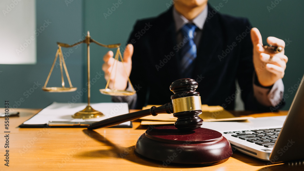 Business and lawyers discussing contract papers with brass scale on desk in office. Law, legal services, advice, justice and law concept picture with film grain effect Business and lawyers discussing contract papers with brass scale on desk in office. Law, legal services, advice, justice and law concept picture with film grain effect