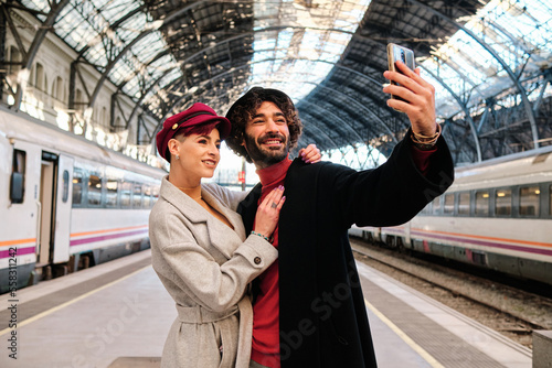 Photography Stylish couple taking a selfie in a train station