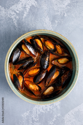 Top view of bowl with mussels soup with tomato sauce