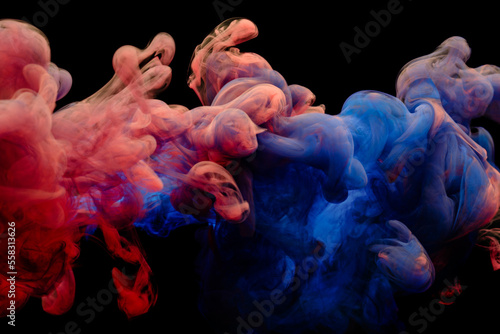 Obraz na płótnie Collision of flow of red and blue ink on a black background. Abstract concept photo w salonie
