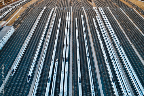 Aerial shots of multiple high-speed trains parked on railway tracks