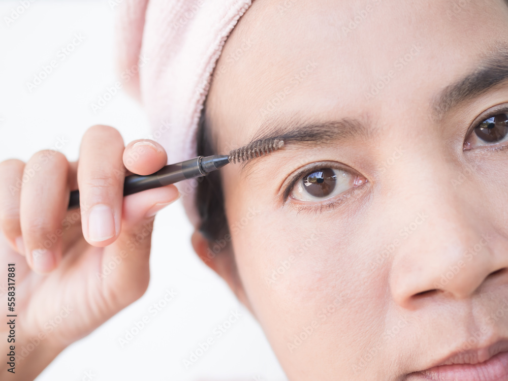 Woman Draw eyebrows Eyebrow Brush Close up,Girl Shaping brows Brushing Eyebrows,Portrait Makeup Face Beauty Cosmetic,Authentic Skin Tan and Black Eyes Asian Thailand. Woman Draw eyebrows Eyebrow Brush Close up,Girl Shaping brows Brushing Eyebrows,Portrait Makeup Face Beauty Cosmetic,Authentic Skin Tan and Black Eyes Asian Thailand.