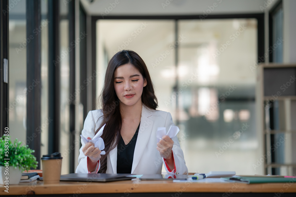 Angry and sad female with failed work in the office. Angry and sad female with failed work in the office.