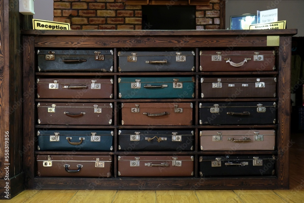Obraz premium Counter at the hotel reception made of old suitcases.