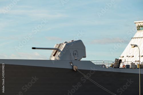 A large cannon on board an army warship. A gun turret on a battleship