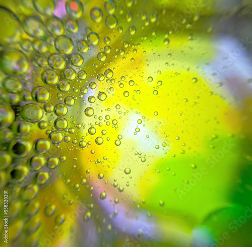 Colorful yellow green mixed abstract background  bubbles in transparent liquid backdrop