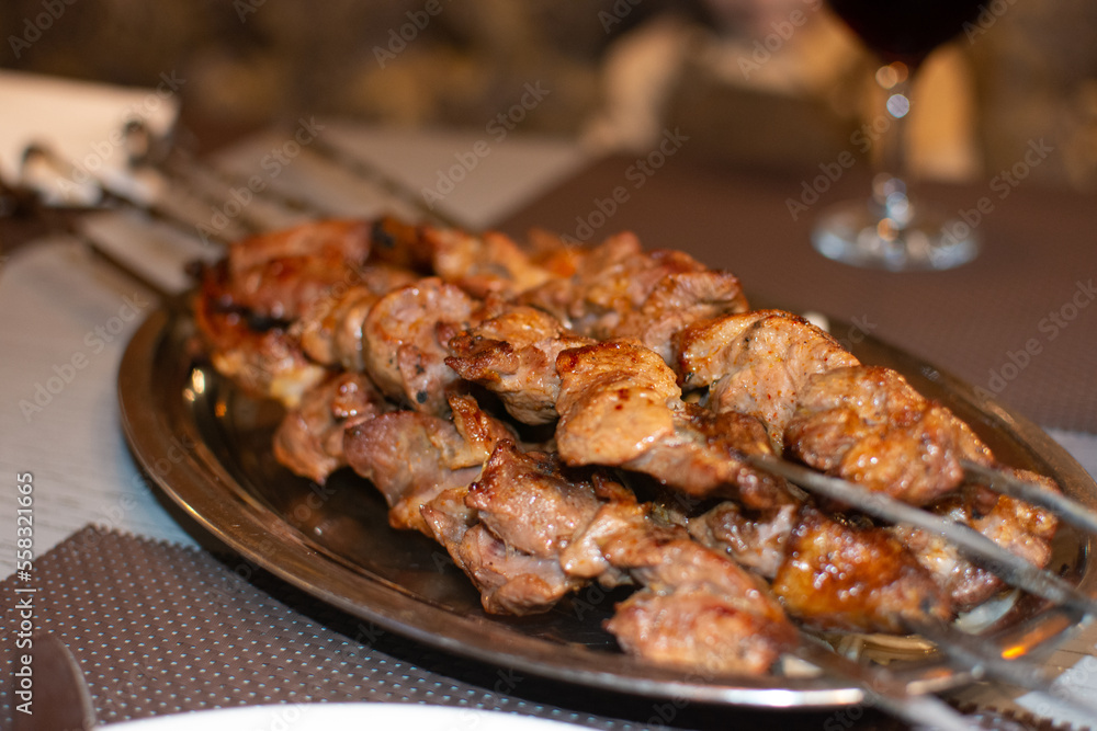 meat cooked on the grill. barbecue on skewers in a metal dish