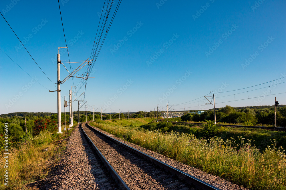 Scenic view of railway tracks turning right in the countryside