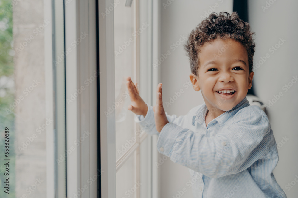 Portrait of little joyful black kid with adorable smile having fun at home Portrait of little joyful black kid with adorable smile having fun at home