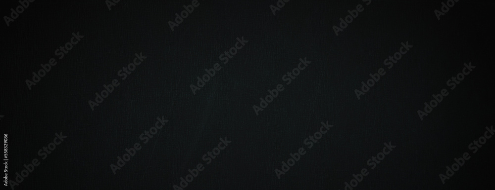 Dark wide panoramic background. Black or dark gray panorama with empty space. Rough worn surface with spots, scratches, noise and grain. Blank darkness background for design. Shaded canvas texture.