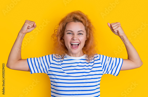 shouting redhead girl face isolated on yellow background. face of young redhead girl